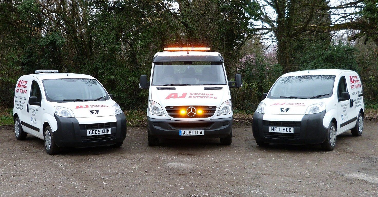 Three AJ Garage Services liveried vans and recovery vehicles