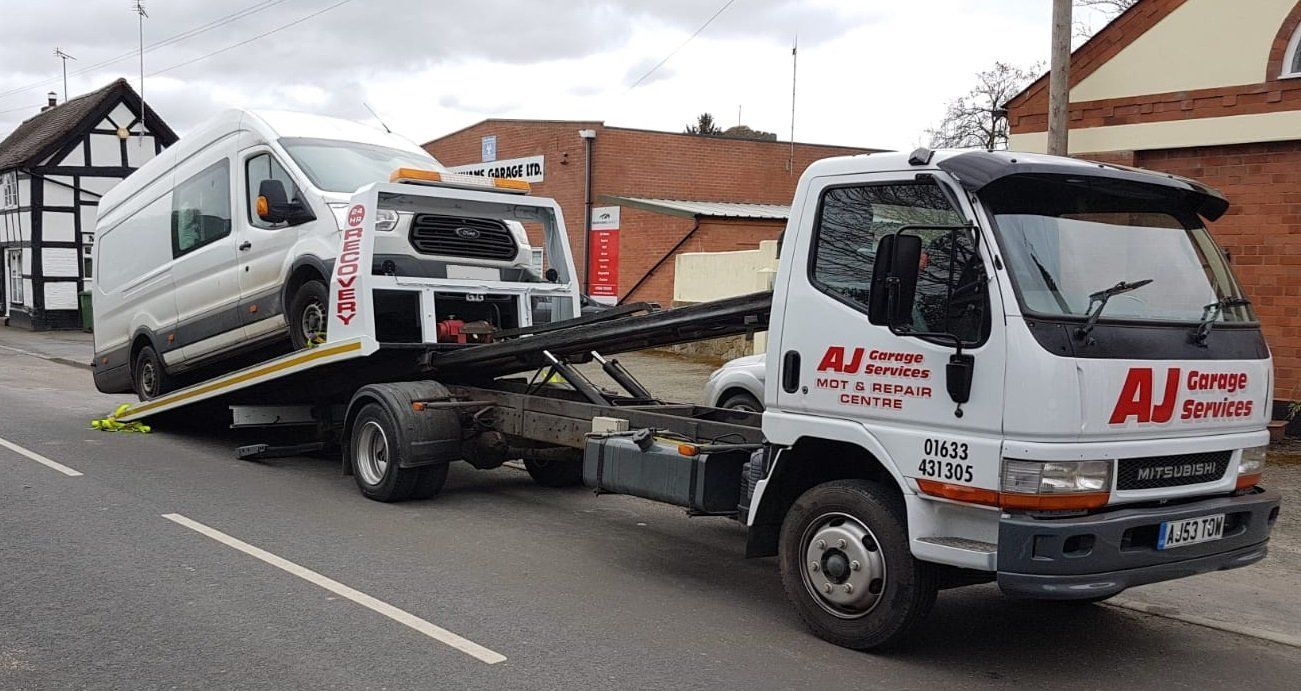 AJ recovery truck carrying a van